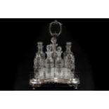 A silver plated cruet, c1880, with seven cut glass bottles