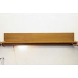 A Benny Linden Danish teak floating shelf, fitted for electricity, 140cm long and 17.5cm deep