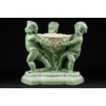 A rare Minton glazed and coloured parian comport, of three putto supporting a basket with bullrushes