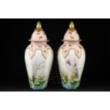 A large pair of Royal Worcester porcelain vases & covers, of hexagonal panelled baluster form,
