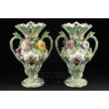 A pair of English porcelain two-handled vases, moulded with leaves and painted with reserves of