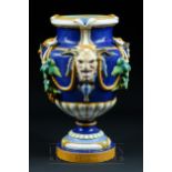 A Minton Bacchus majolica pottery urn, shape no. 640, modelled with garlands and satyr masks, bright