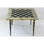 A marble chess board, mounted on metal table base