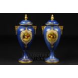 A pair of Royal Worcester vases & covers, signed E. Townsend, powder blue ground with reserves of