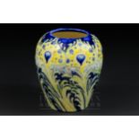 A Moorcroft MacIntyre Florian ware peacock pattern vase, tubelined decoration in tones of yellow,