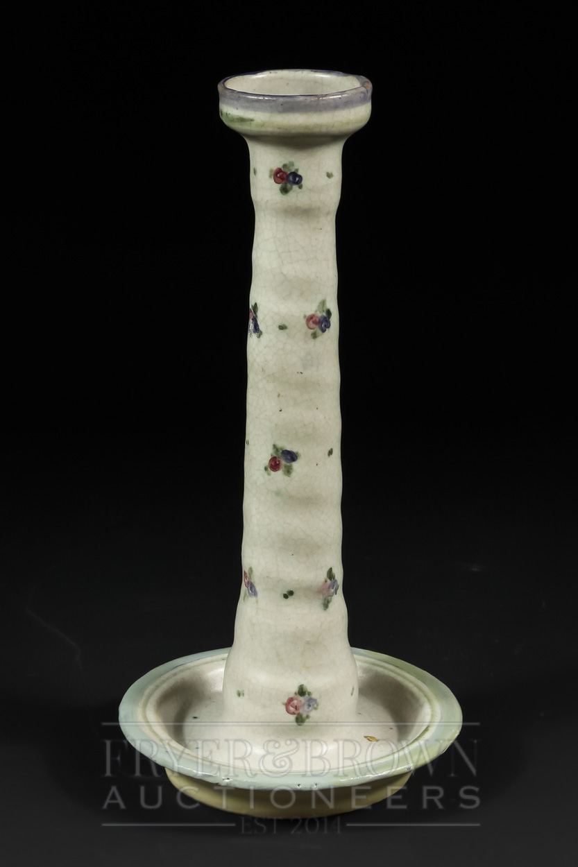 A Carter, Stabler, Adams Poole Pottery candlestick, the pale grey ground decorated with floral