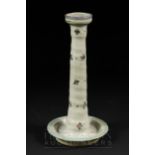 A Carter, Stabler, Adams Poole Pottery candlestick, the pale grey ground decorated with floral