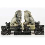 A pair of Chinese soapstone dogs of fo, mottled green colouration; and two further pairs, black