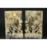 A pair of Chinese soapstone bookends carved with flowering peony flowers, 18cm high (2)