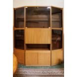 A Benny Linden Danish teak display unit in three sections, the centre unit with double glass doors
