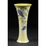 A rare Moorcroft lustre vase of trumpet form, the pale yellow lustre ground decorated with grapes