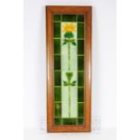 A Minton tile panel of a budding sunflower, six tiles, mounted with dark green border tiles, framed,