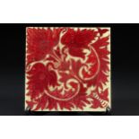 A Craven Dunnill ruby lustre tile, decorated with a William de Morgan design of stylised anthemion