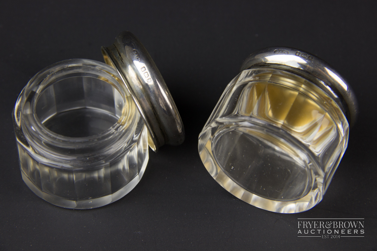 A pair of cut glass rouge pots, the silver lids with gilt interiors and engine turned decoration top - Image 2 of 2