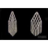 An attractive pair of finely made 18 carat white gold pendant earrings, the pyramid shaped tops with