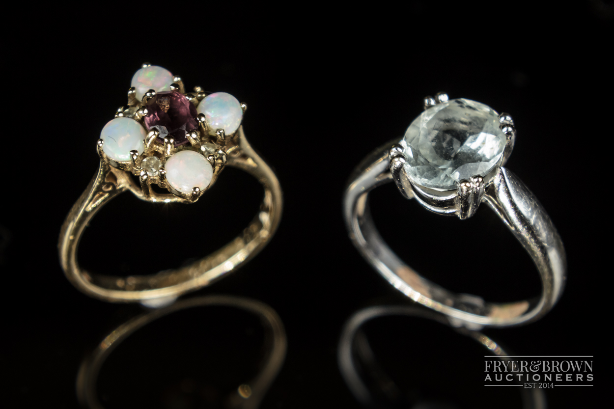 An 18 carat white gold and opal mixed cut aquamarine single stone ring; and an opal & ruby 8/8 cut