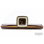 An Art Deco mantle clock , 66 cm long, shelf to either side of square face clock, Westminster