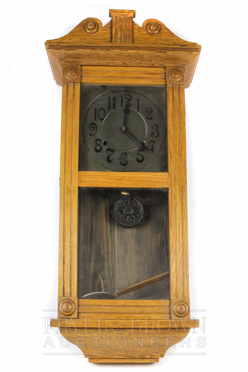 An American oak cased Arts & Crafts striking wall clock, the metal dial marked Made in the United