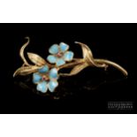 A 1960s 18 carat gold, enamel and ruby brooch, the spray composed of two turquoise enamel flowers