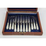 A set of six silver plate dessert knives and forks with mother of pearl handles, in fitted box