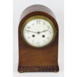 A French walnut mantel clock with enamel face, on brass bun feet, numbered 129C52