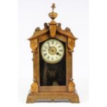 An English Arts & Crafts clock, surmounted by a vase finial, 46.5cm