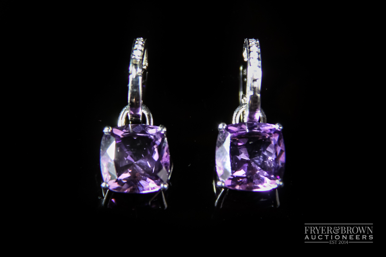Kiki McDonough An attractive pair of 18 carat white gold and amethyst and diamond earrings, the