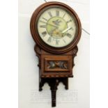 An American walnut wall clock, the circular metal dial painted with a swift and roses above a