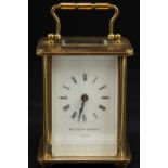 A Matthew Norman carriage clock, the white enamel face with Roman numerals, with key