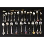 A silver collectors spoon; other white metal souvenir spoons, 800 and 935 marks, some enamel