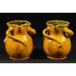 A pair of William Baron, Barnstaple, Liberty style vases, money bag form with three swirled handles,