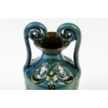 A C.H. Brannum Pottery vase, in Liberty style, of urn form with scroll handles, tubelined with