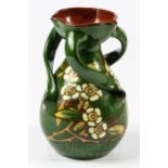 A William Baron, Barnstaple, spiralled three-handled vase, decorated with flowering canes on a