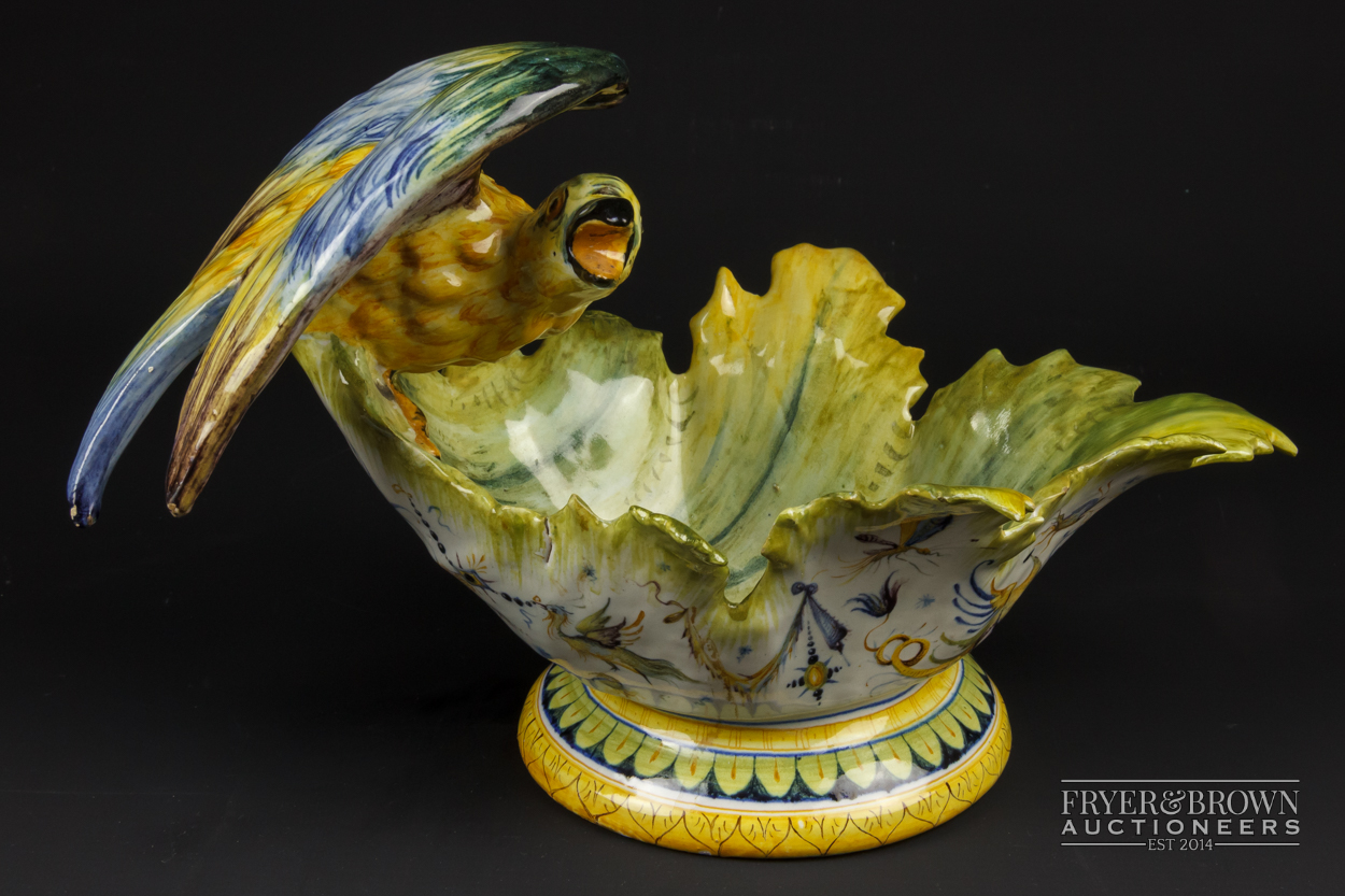 A Cantagalli maiolica bowl, formed as a large bird perched upon a leaf form bowl, decorated in