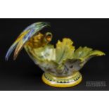 A Cantagalli maiolica bowl, formed as a large bird perched upon a leaf form bowl, decorated in