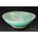 A large Kashan pottery bowl, turquoise glaze, incised with a band of cloud motifs, 34cm diameter