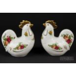 A pair of Royal Albert 'Old Country Roses' hen or rooster figures, modelled seated, with gilded