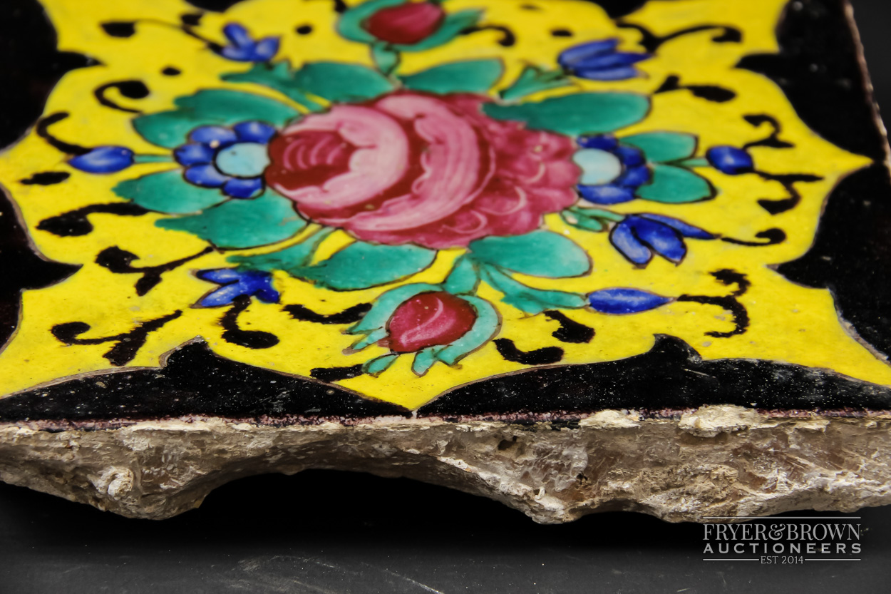 A Qajar tile, brightly glazed with a Damascus rose, two buds and blue flowers on a yellow reserve, - Image 3 of 3