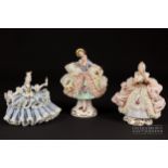 Two small Dresden porcelain lace crinoline figures in Marie Antoinette style; and another, 10.5cm