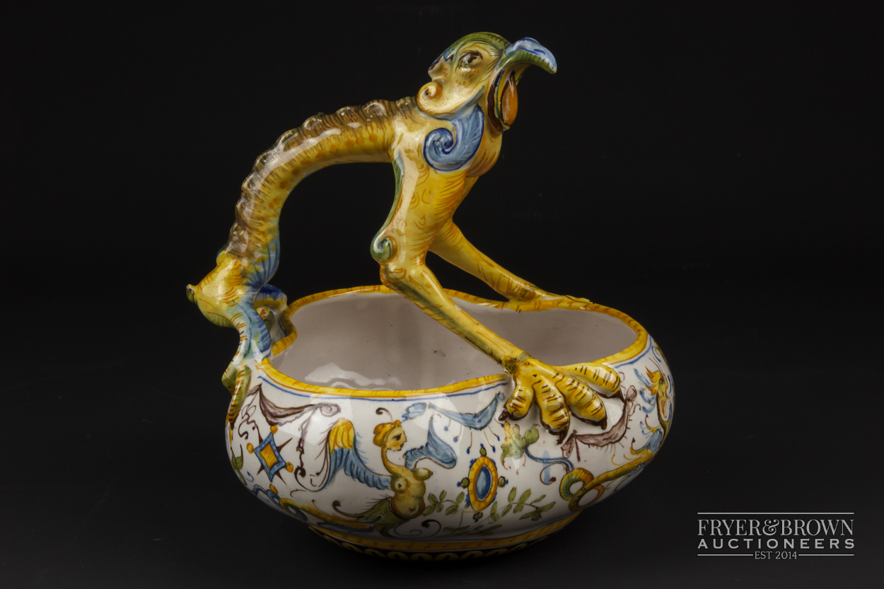 A Cantagalli maiolica trefoil bowl, the handle formed as a grotesque bird, decorated in Urbino style