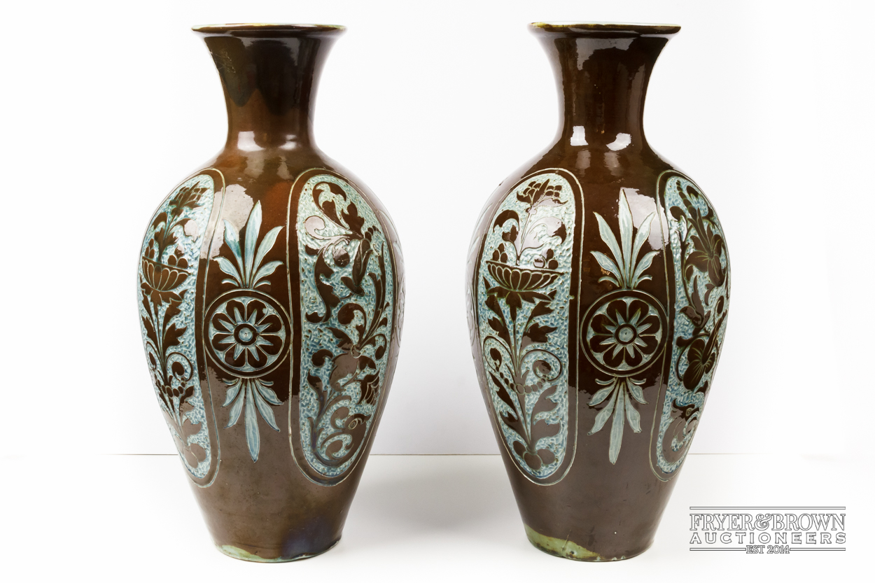 A pair of large C.H. Brannam pottery vases, slender ovoid for with trumpet neck, brown incised to