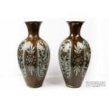 A pair of large C.H. Brannam pottery vases, slender ovoid for with trumpet neck, brown incised to