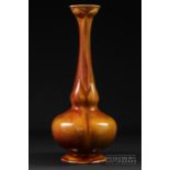 A Royal Worcester/Sabrina ware leadless glaze vase, of rose water sprinkler form, glazed in orange/