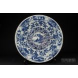 A Chinese blue & white porcelain charger, painted with reserves of figures in landscapes on a finely