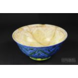 A Safavid lustre pottery bowl, the interior decorated in yellow/ochre with leaves in spandrels,