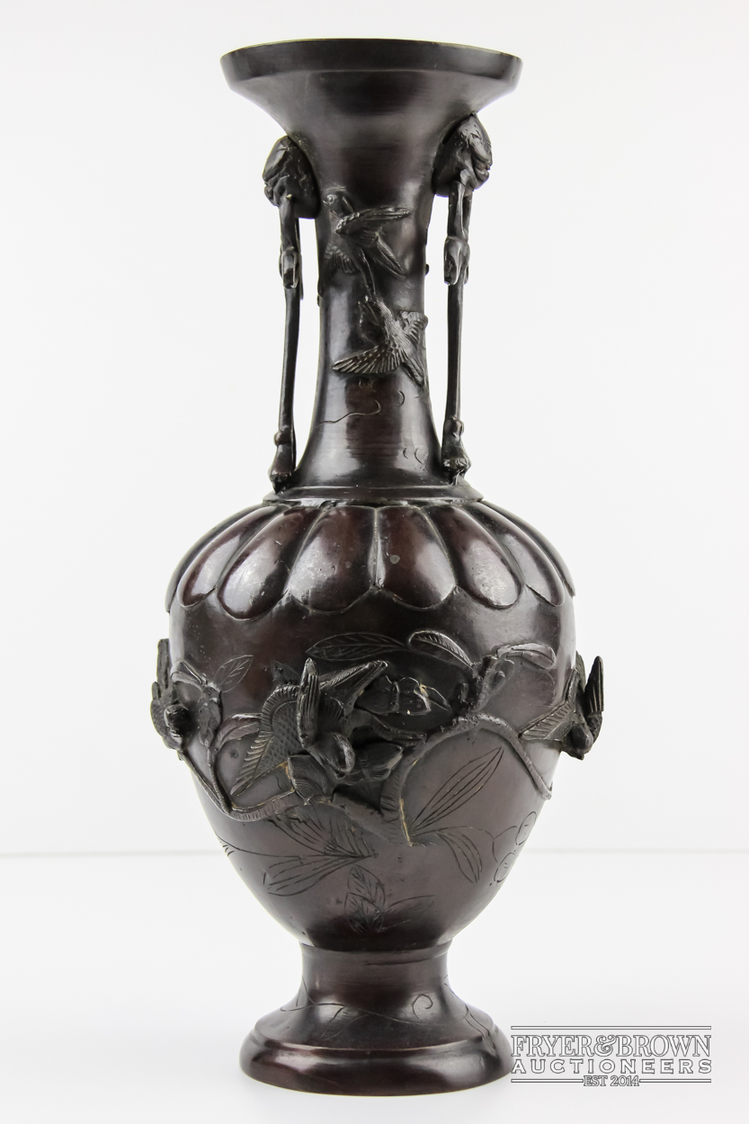 A bronze bottle neck vase, decorated with birds, foliage and grotesques, c1900, 37.5cm high approx.