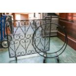 A circular cast iron magazine rack; and a cast iron fire guard (2)