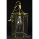 A hexagonal brass and glass hanging porch lantern