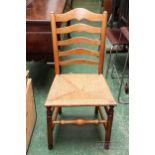 A light oak single dining chair with rush seat