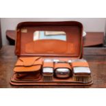 A vintage gentleman's grooming set, in tan leather case